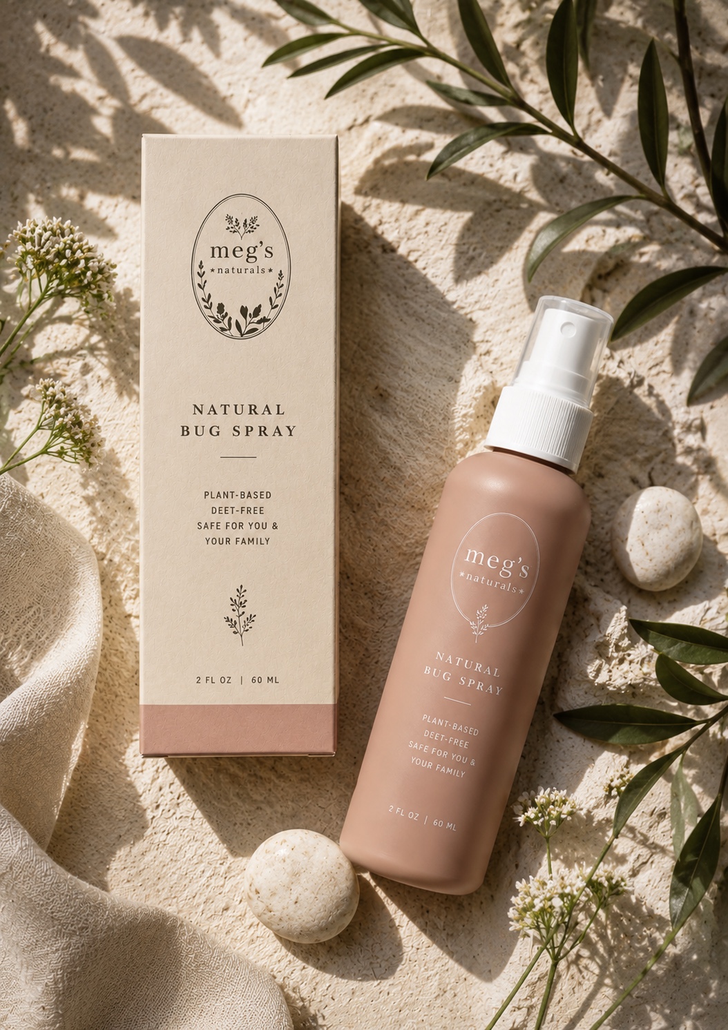 Megs Naturals blush natural bug spray and carton arranged with soft botanical shadows